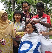 women shaving head spr protest 060308 shaving