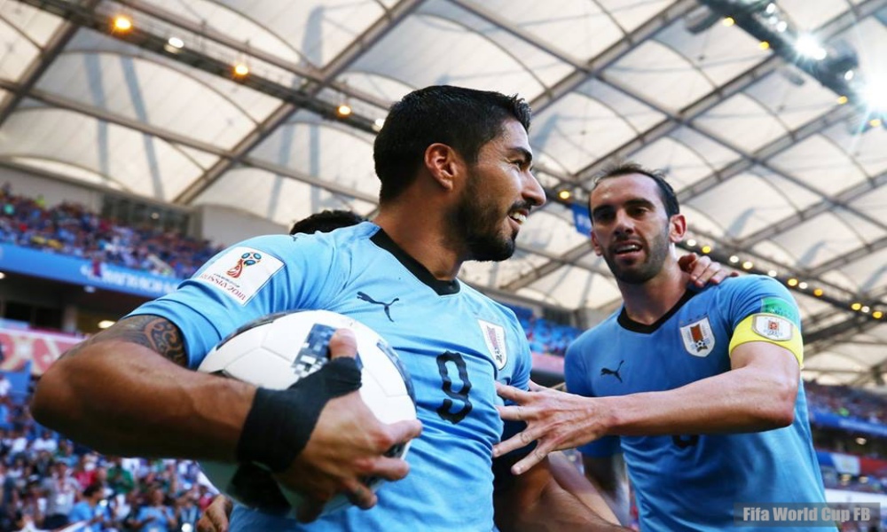Suarez marks 100th cap with goal to send Uruguay through to last 16