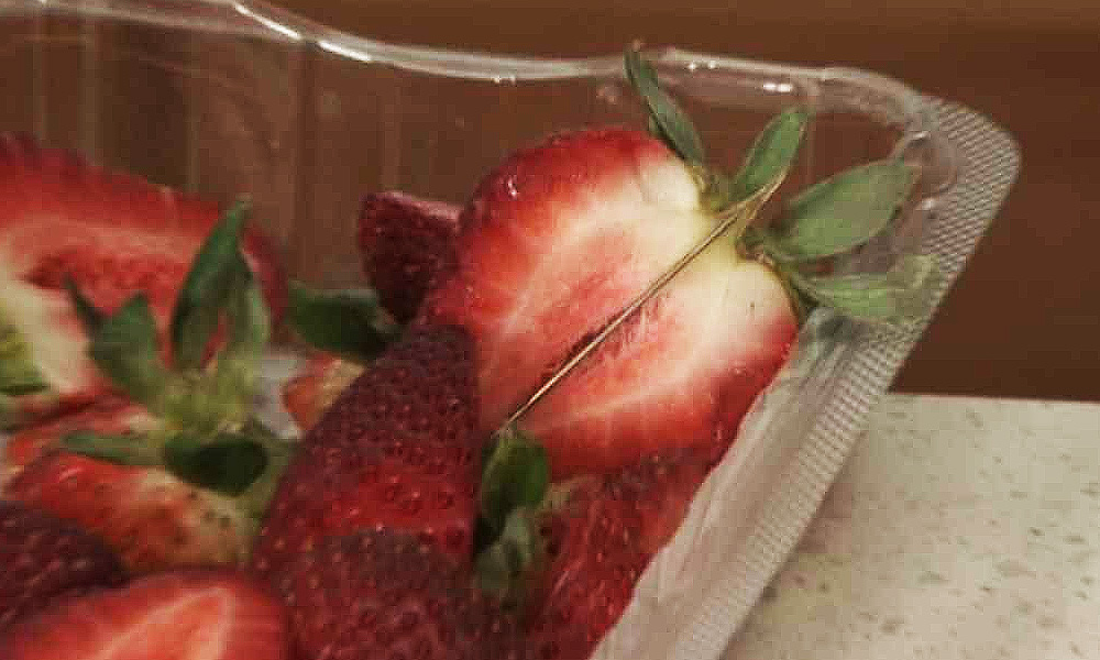 Australian woman charged with contaminating strawberries with needles