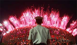 beijing olympic games bird nest stadium with military personnal looking at fireworks display 040808