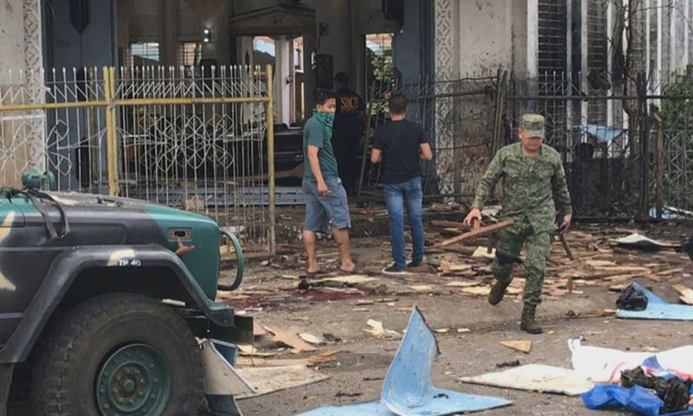 Philippines vows to 'crush godless criminals' after church bombs kill 27