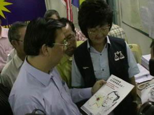 leow tiong lai and mca leader look at leaflet 220808