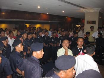 umno agm scuffle 250309 police human fence 01
