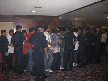 umno agm scuffle 250309 police human fence 02