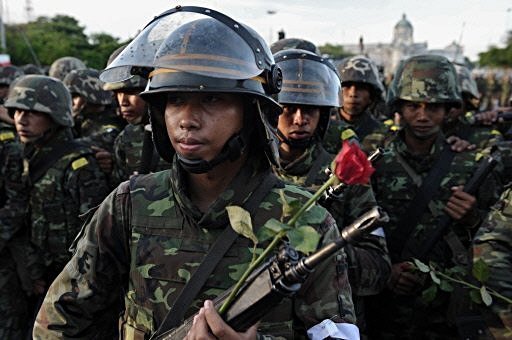 Thai troops battle protesters in Bangkok streets.