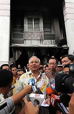 PM Najib Razak speaks to the press outside the gutted administrative block of Metro Tabernacle church 1