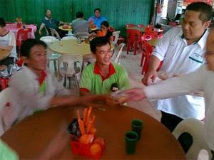 PAS handing moon cakes to Chinese