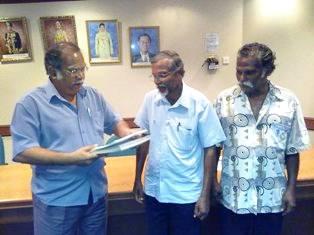 ramasamy receiving documents regarding land scheme from settlers