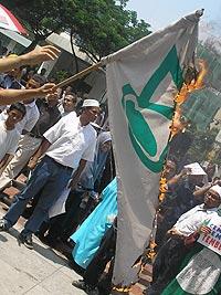 petrol price hike protest 2 100306 petronas flag burned