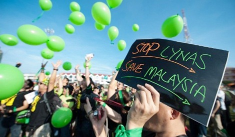 An anti Lynas activist displays a placard during a Green Gathering 2.0 in Kuantan 2