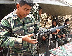 malaysia army soldier inspecting weapon