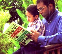 father and son reading a book