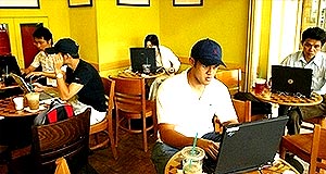 malaysian online laptop remote user in coffee cafe